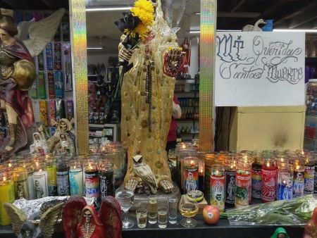 Votive candles placed before a holy statue